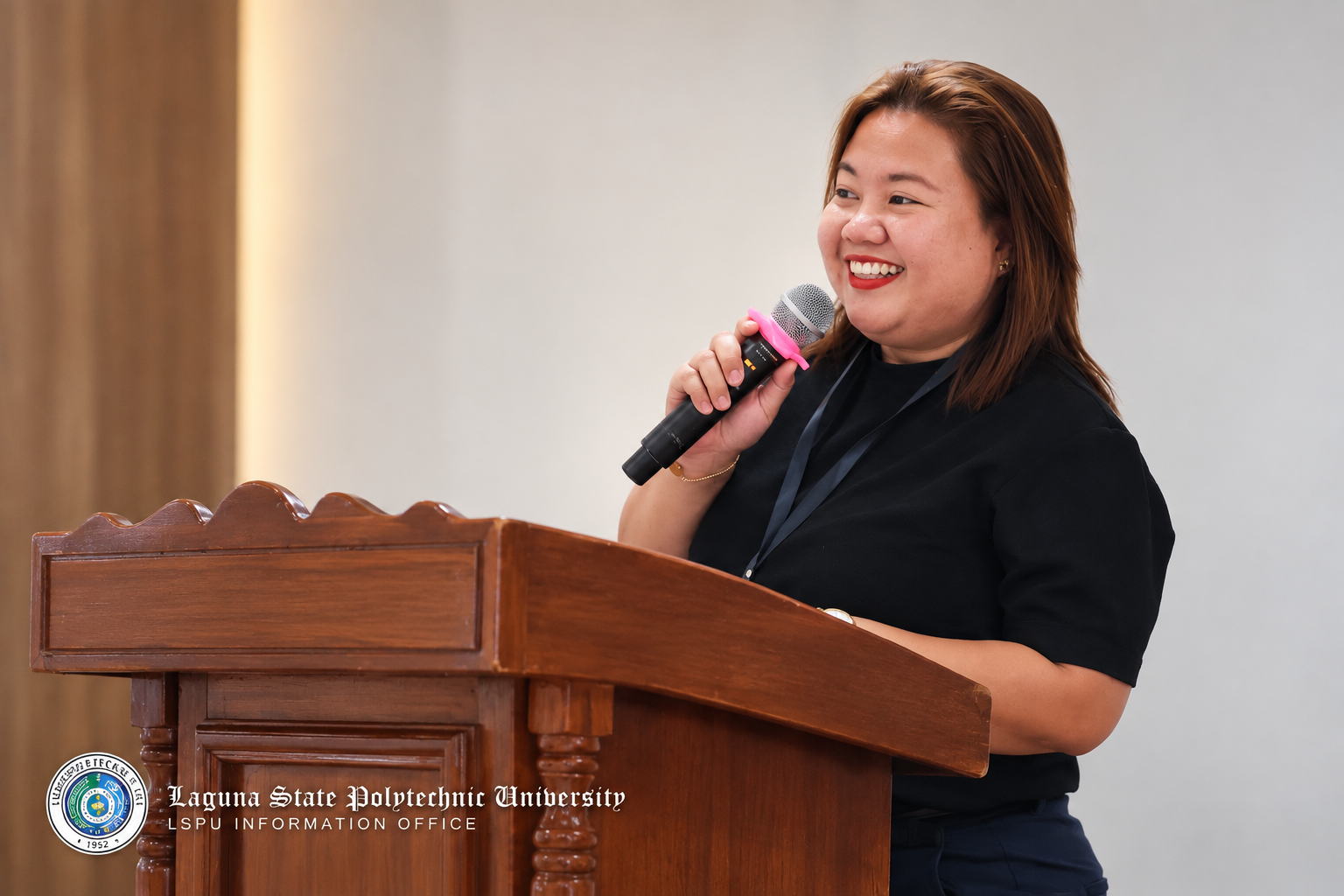 HM Juanillas speaking at a lectern during a professional event.